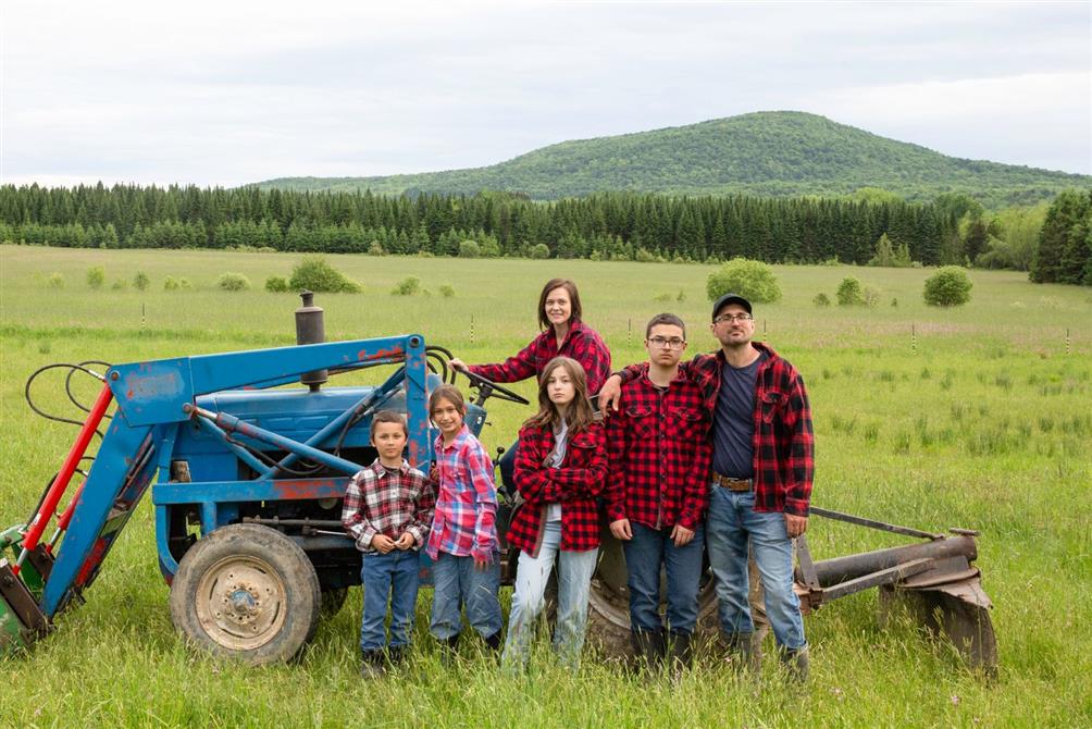 The Fromagerie Brebis de Bromont family by the tractor at the farm